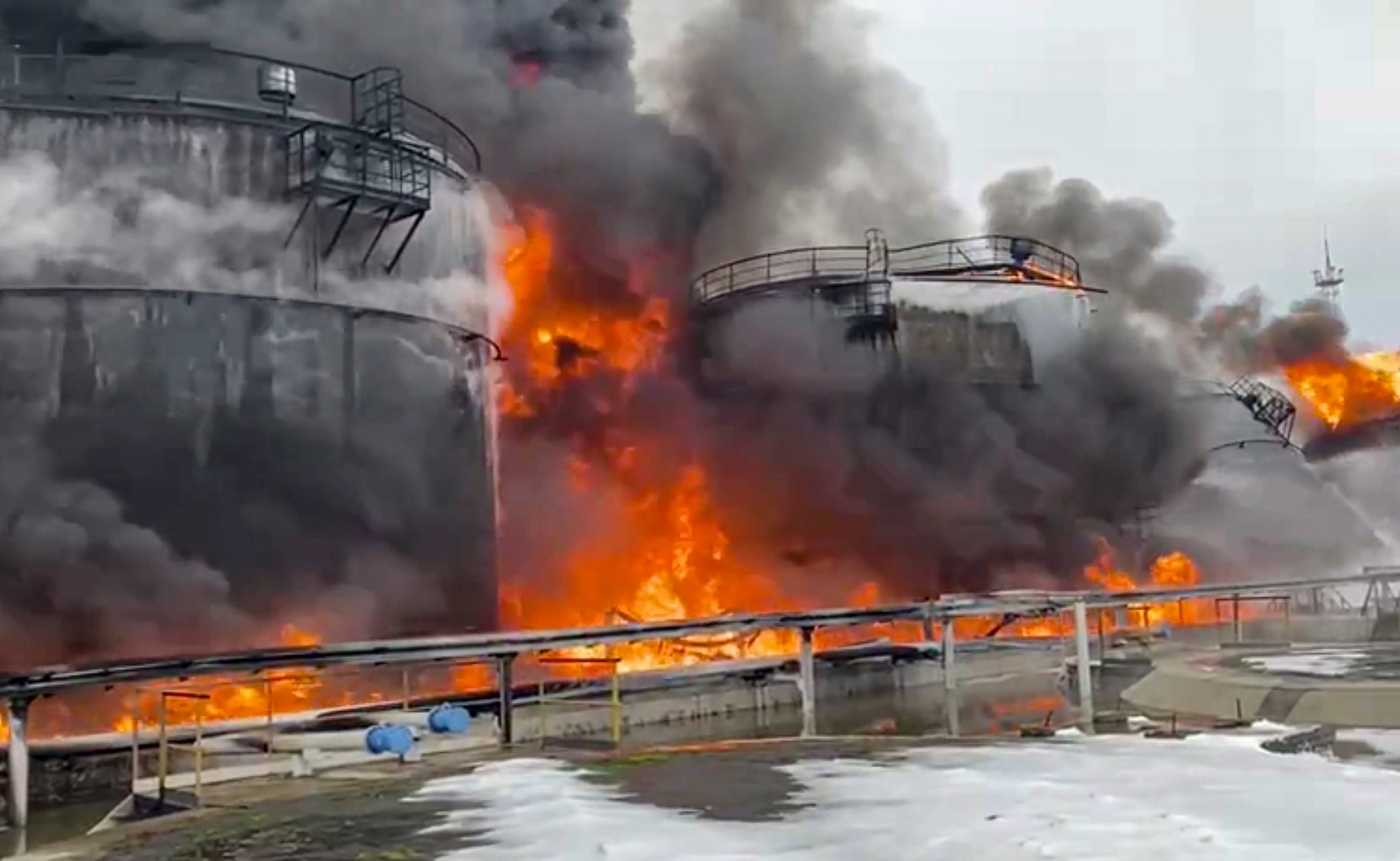 <p>Russian firefighters extinguishing a fire following a reported drone attack on the territory of the Klintsevskaya oil depot, near Bryansk</p>