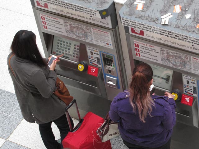 <p>Price sensitive: passengers using ticket machines at a London station</p>