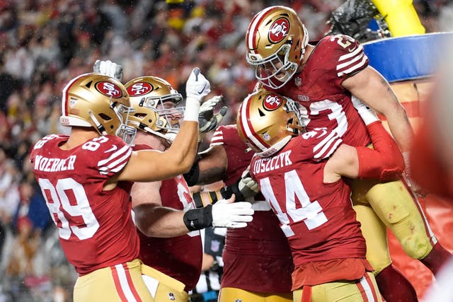San Francisco 49ers running back Christian McCaffrey, right, celebrates his touchdown (Ashley Landis/AP)