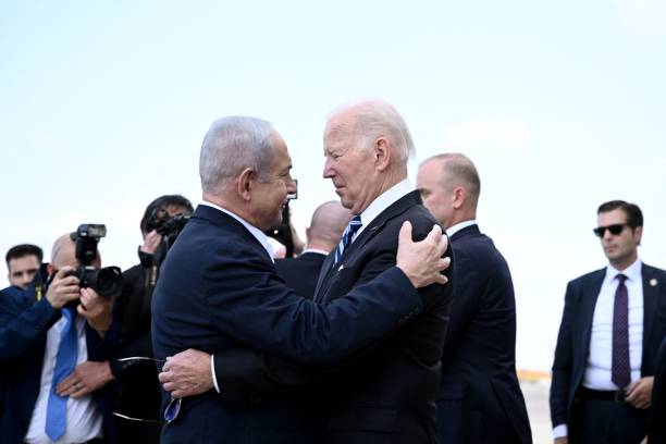Israel Prime Minister Benjamin Netanyahu (L) greets US President Joe Biden upon his arrival at Tel Aviv’s Ben Gurion airport on October 18, 2023, amid the ongoing battles between Israel and the Palestinian group Hamas