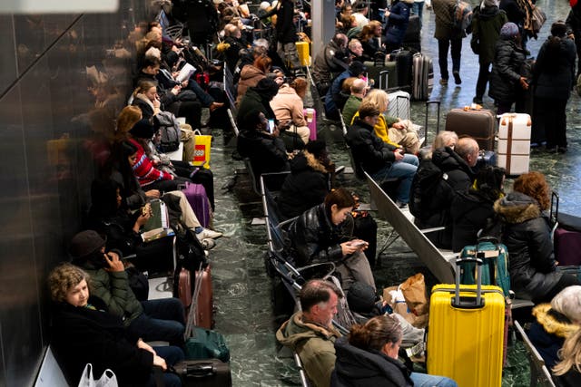 <p>Passengers at Euston station, London, following train delays as Storm Isha has brought severe disruption to rail services</p>
