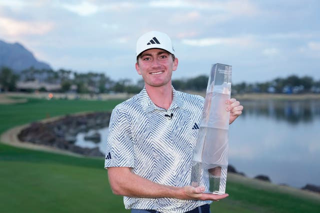 Nick Dunlap holds the trophy after winning the American Express golf tournament (Ryan Sun/AP)