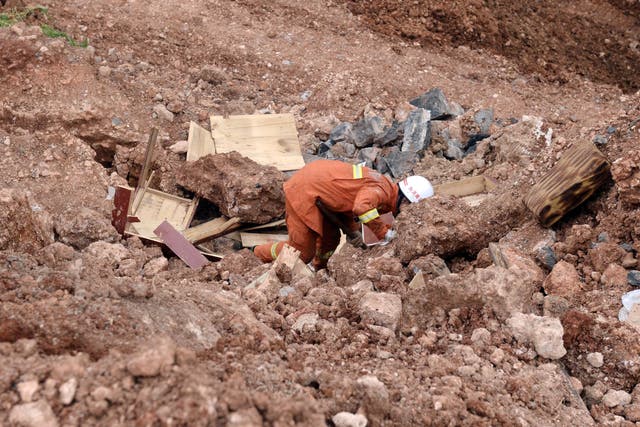<p>File: Rescue worker searching for victim in debris  in China’s Yunnan province following a landslide on 7 August 2014</p>