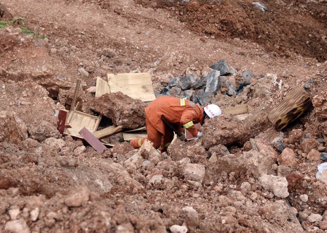 <p>File: Rescue worker searching for victim in debris  in China’s Yunnan province following a landslide on 7 August 2014</p>