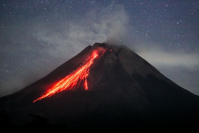 <p>File: Mount Merapi spews lava onto its slopes during an effusive eruption as seen from Wonokerto village, Yogyakarta</p>