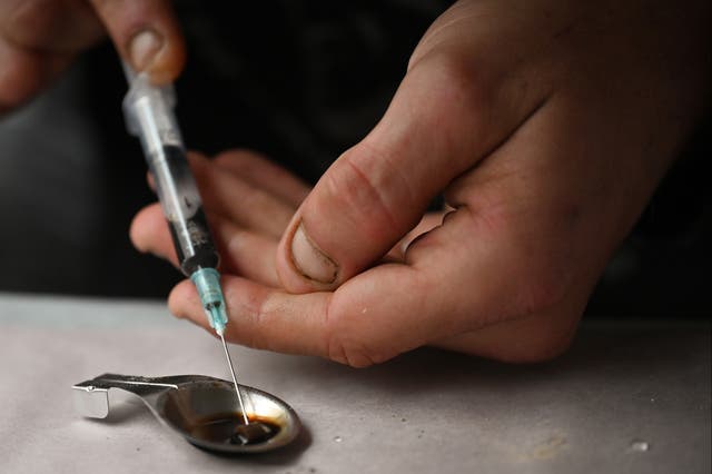 <p>Drug users prepare heroin before injecting at an overdose prevention centre set up in Glasgow by activist Peter Krykant in 2020 </p>