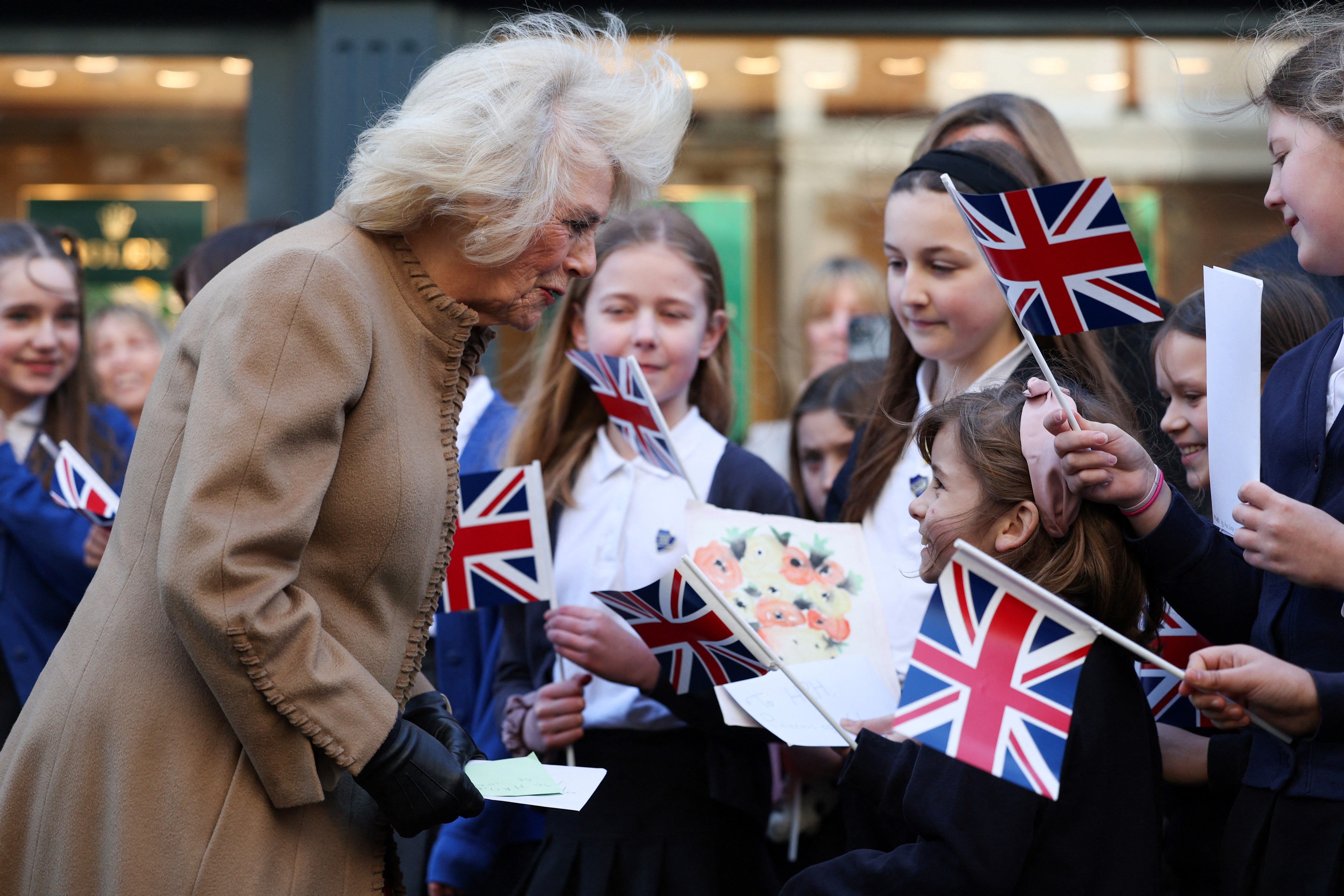 Queen Camilla receives get well cards for King Charles during a visit to Deacon & Son Jewellers in Swindon, western England on Monday