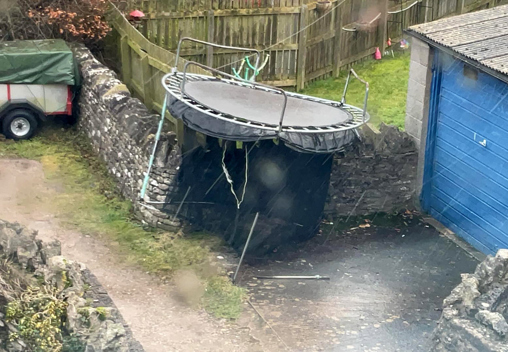 A trampoline deposited on a wall in Kirkby Stephen, Cumbria, after gusts from Storm Isha removed it from a nearby in a garden