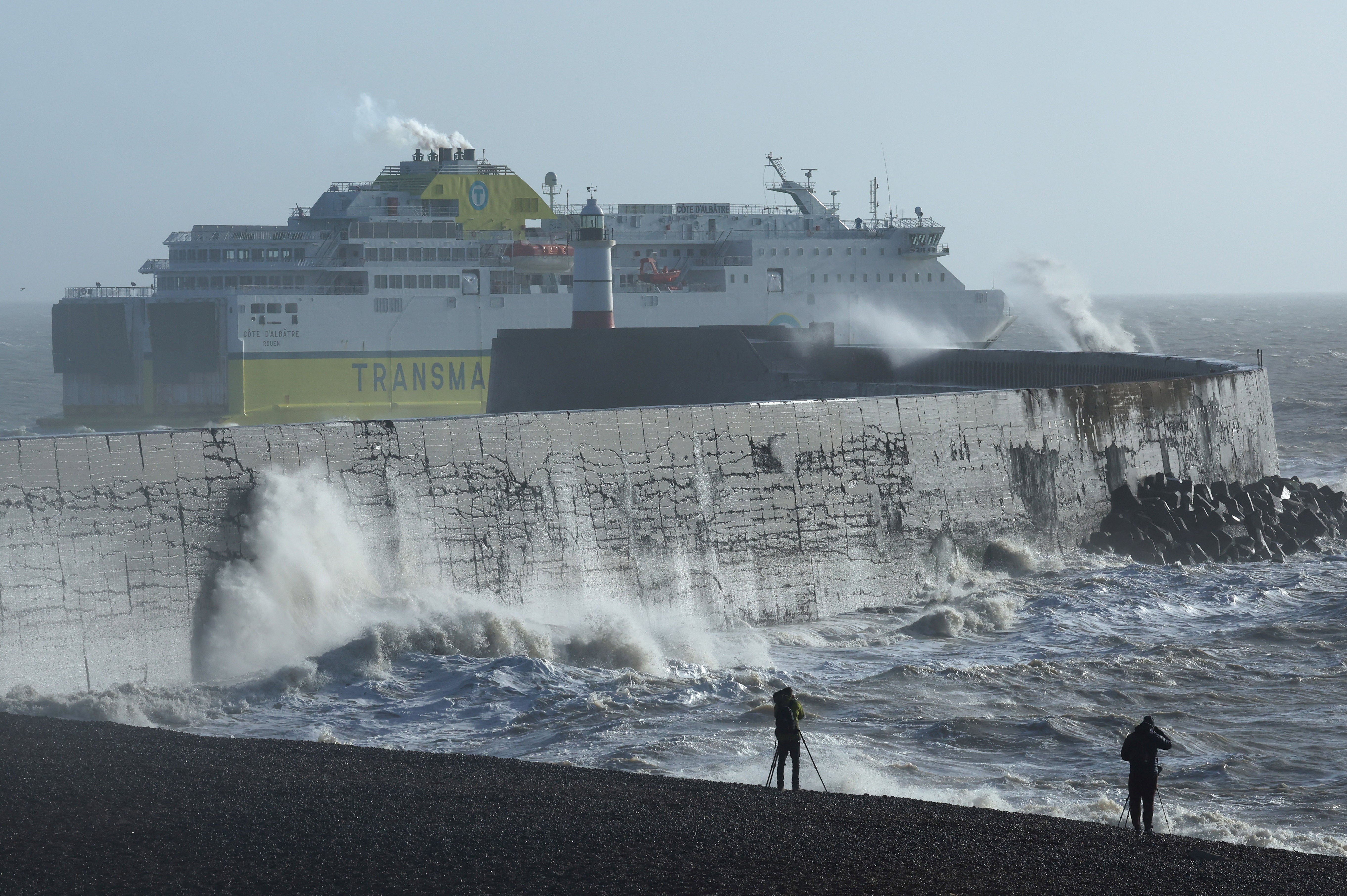 A cross-Channel ferry departs Newhaven for France as large waves hit the seawall and harbour during Storm Isha in Newhaven, southern Britain,