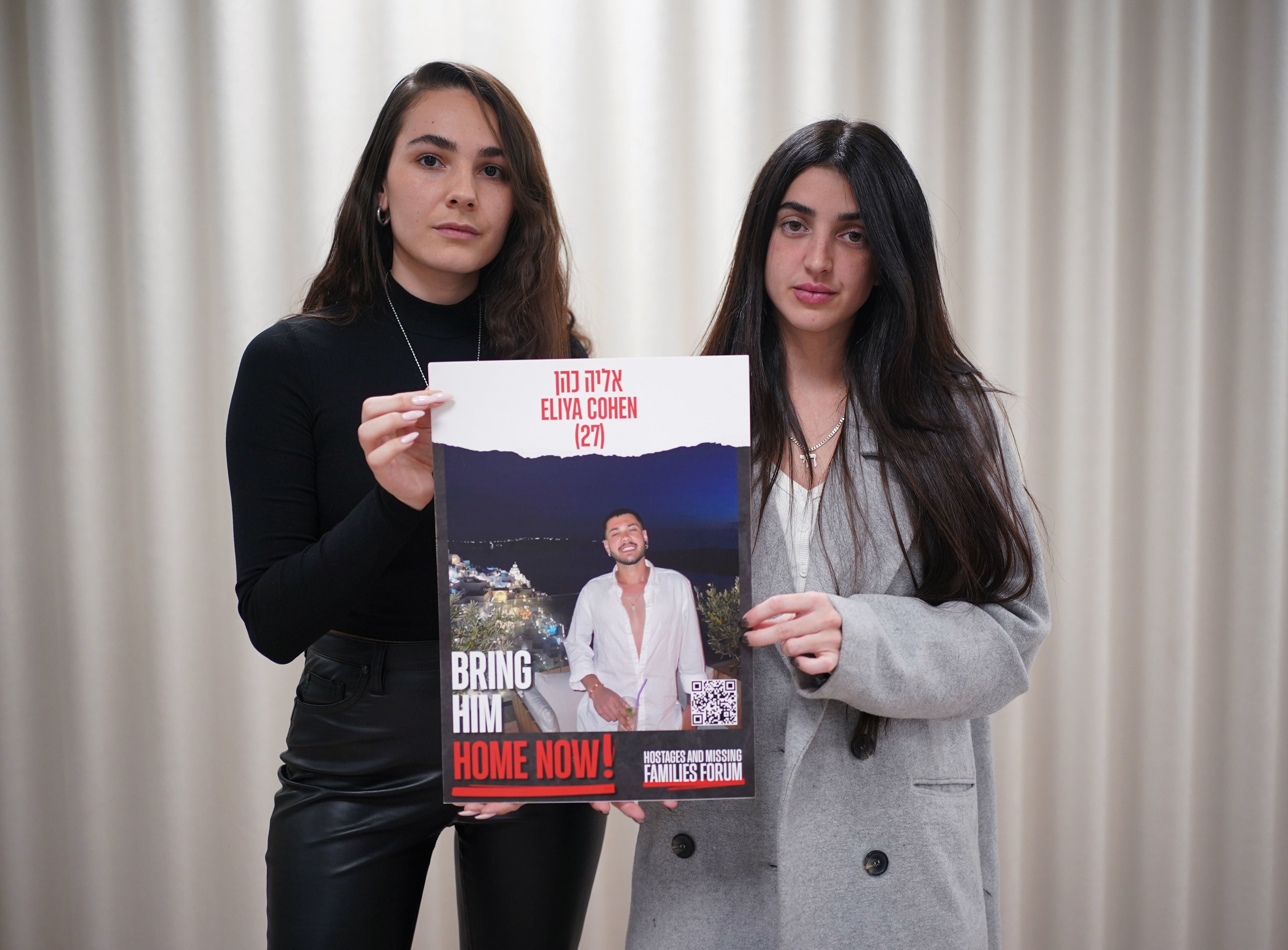 Ziv Abud (right) and friend Michael Rahoom hold a poster of Eliya Cohen while raising awareness of his plight in London in January 2024
