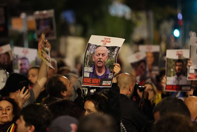 <p>Protesters hold up portraits of Israeli hostages held in Gaza during a rally in Jerusalem</p>