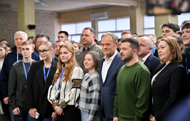 <p>Ukrainian president Volodymyr Zelensky and Polish prime minister Donald Tusk pose fwith Ukrainian students after their meeting in Kyiv on Monday </p>
