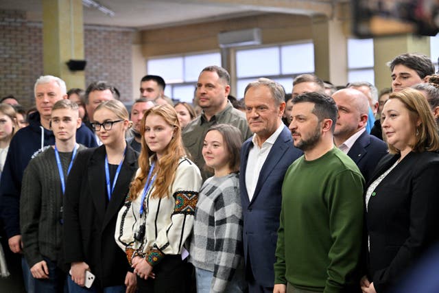 <p>Ukrainian president Volodymyr Zelensky and Polish prime minister Donald Tusk pose fwith Ukrainian students after their meeting in Kyiv on Monday </p>