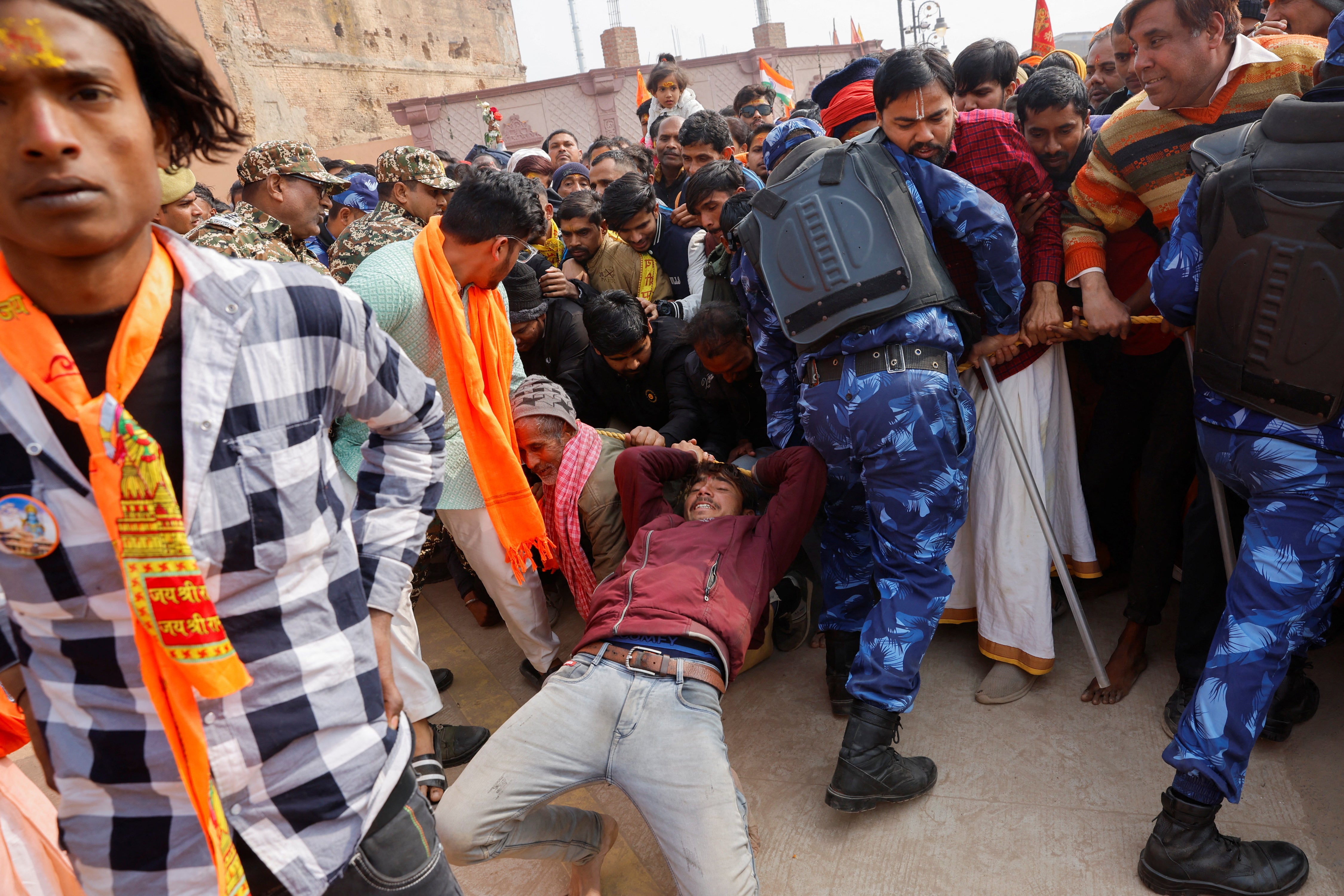 <p>Hindu devotees struggle to enter the temple which was rebuilt following its destruction in 1992 </p>