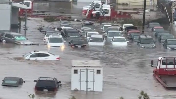 Cars swept down swamped roads as flooding wreaks havoc across San Diego