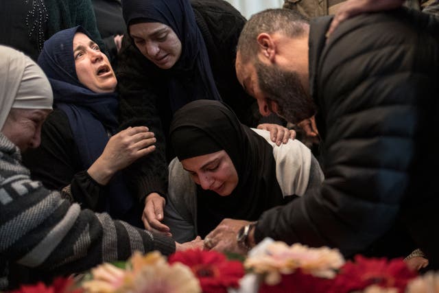 <p>The mother of 17-year-old Palestinian Tawfic Abdel Jabbar mourns over his body before a funeral procession in the Israeli-occupied West Bank on 20 January. </p>