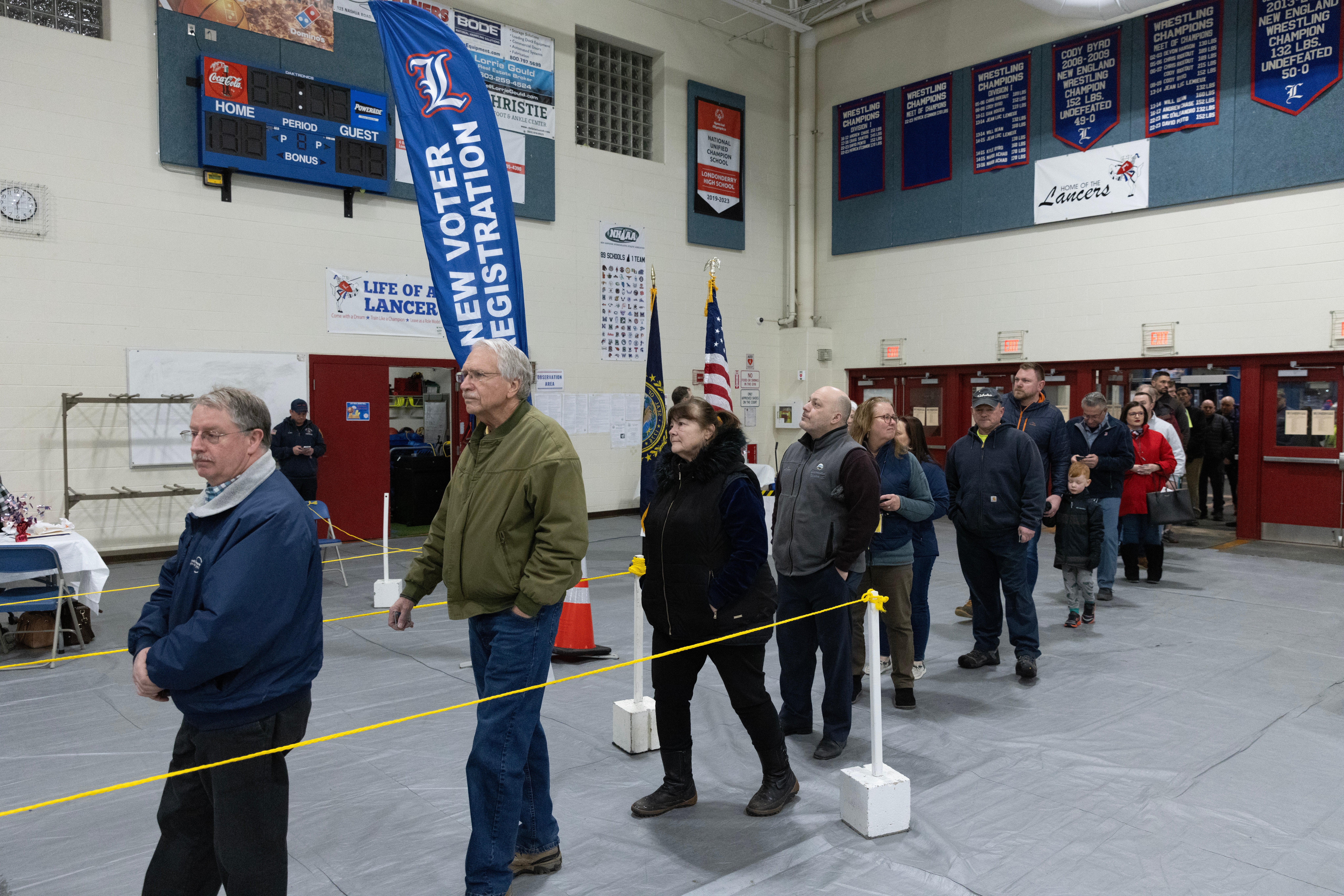 

<p>Voters wait in line to get a ballot and vote in the New Hampshire primary, at a voting site at Londonderry High School in Londonderry, New Hampshire</p>
<p>” peak=”5464″ width=”8192″ structure=”responsive” i-amphtml-layout=”responsive”><i-amphtml-sizer slot=