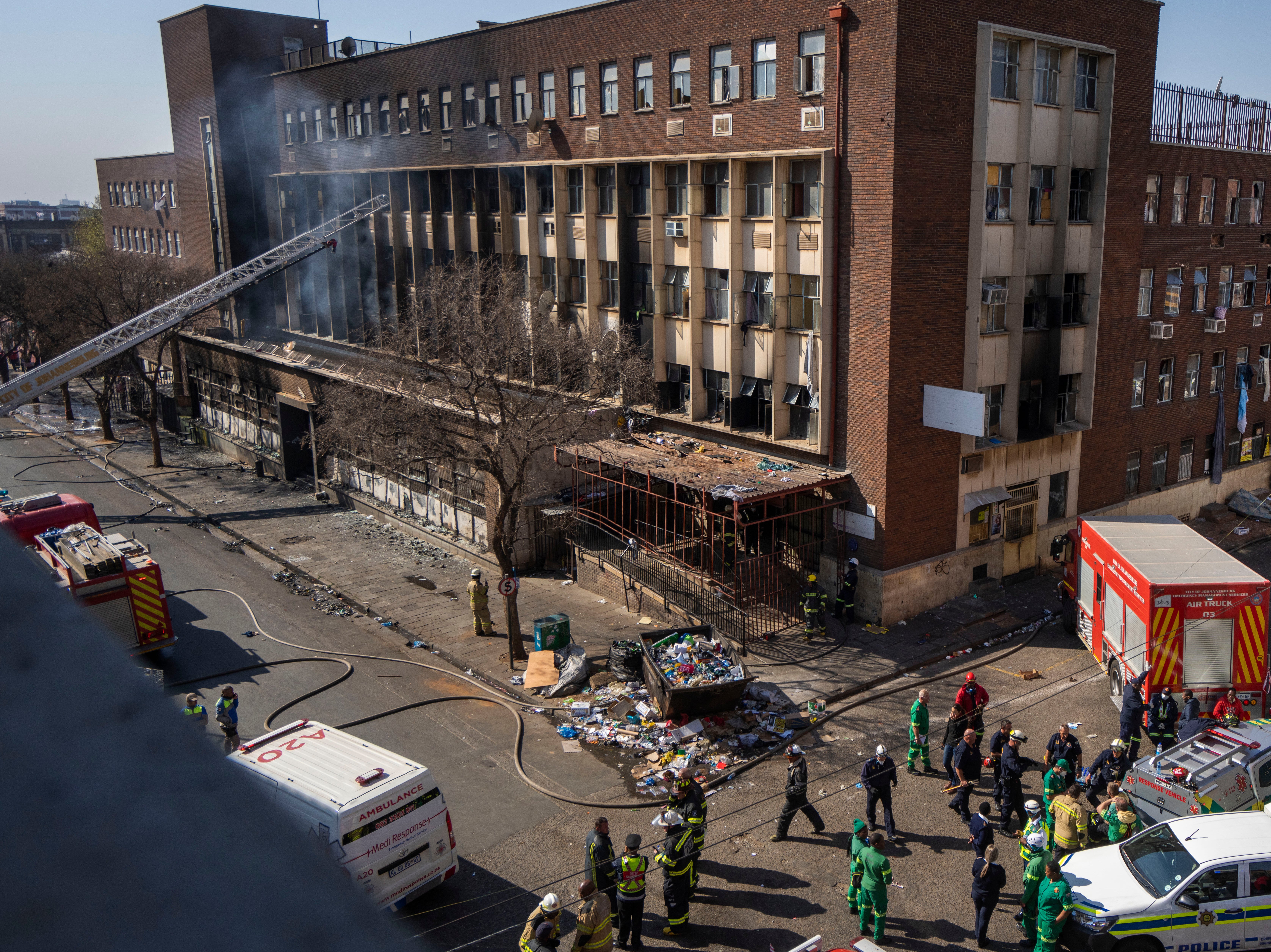 Medics and emergency works at the scene of the deadly blaze in downtown Johannesburg in August