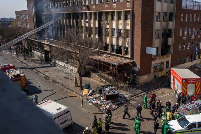 <p>Medics and emergency works at the scene of the deadly blaze in downtown Johannesburg in August </p>