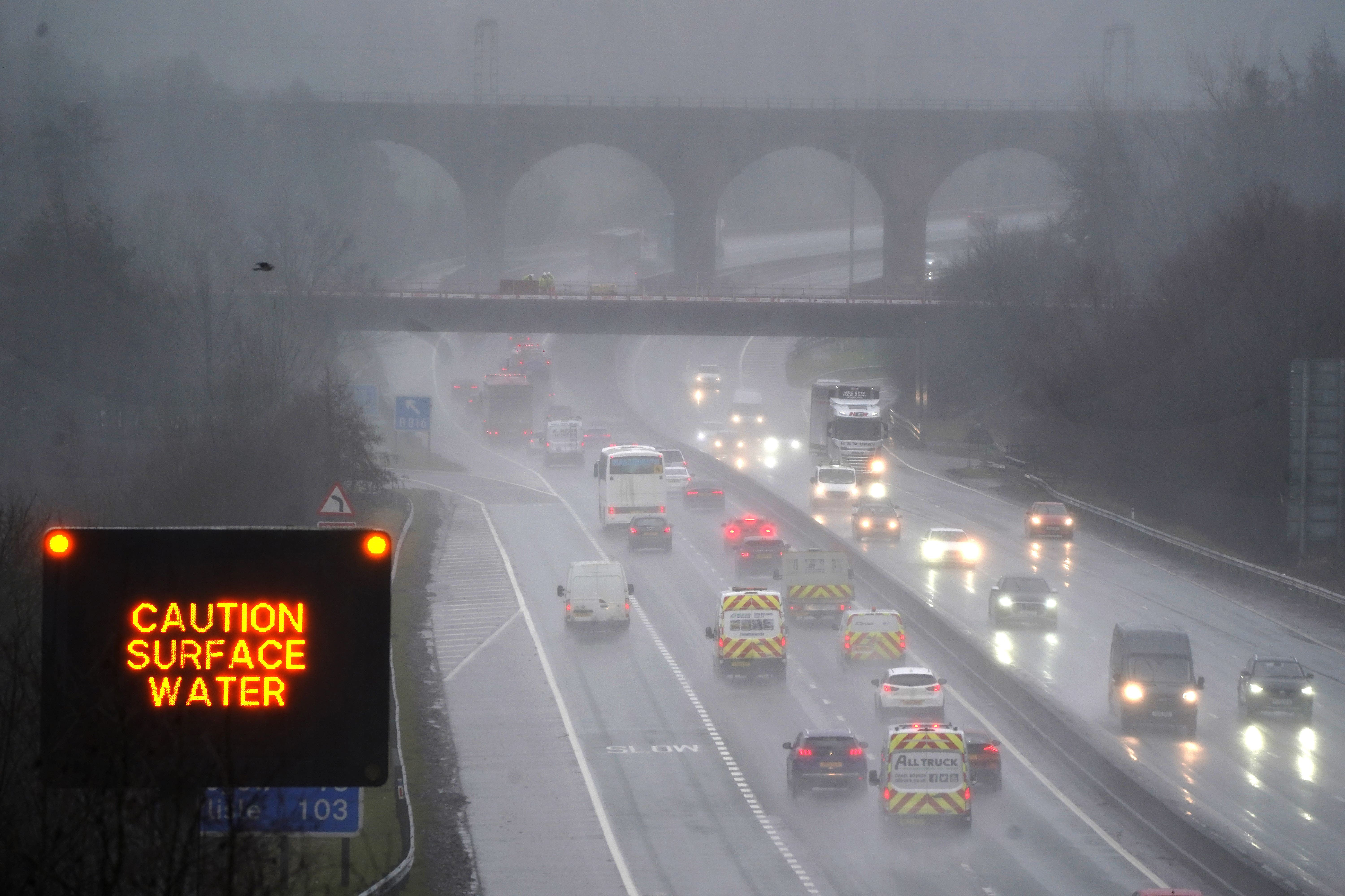 Vehicles make their way through heavy rain on the M80 near Banknock (Andrew Milligan/PA)