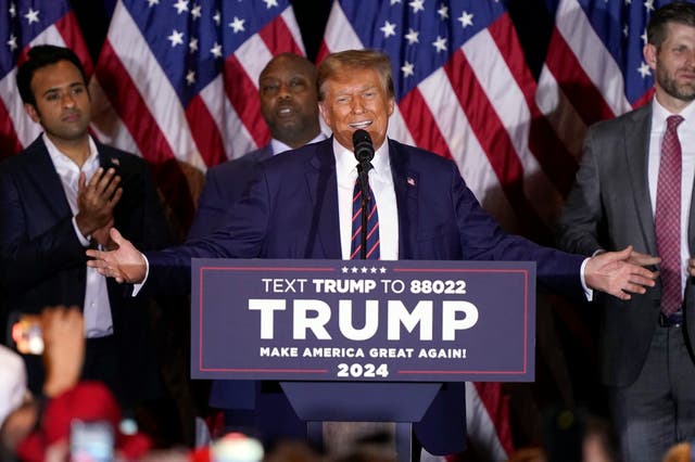 <p>Republican presidential candidate former President Donald Trump speaks at a primary election night party in Nashua, N.H., Tuesday, Jan. 23, 2024. Watching from left are Vivek Ramaswamy, Sen. Tim Scott, R-S.C.,</p>
