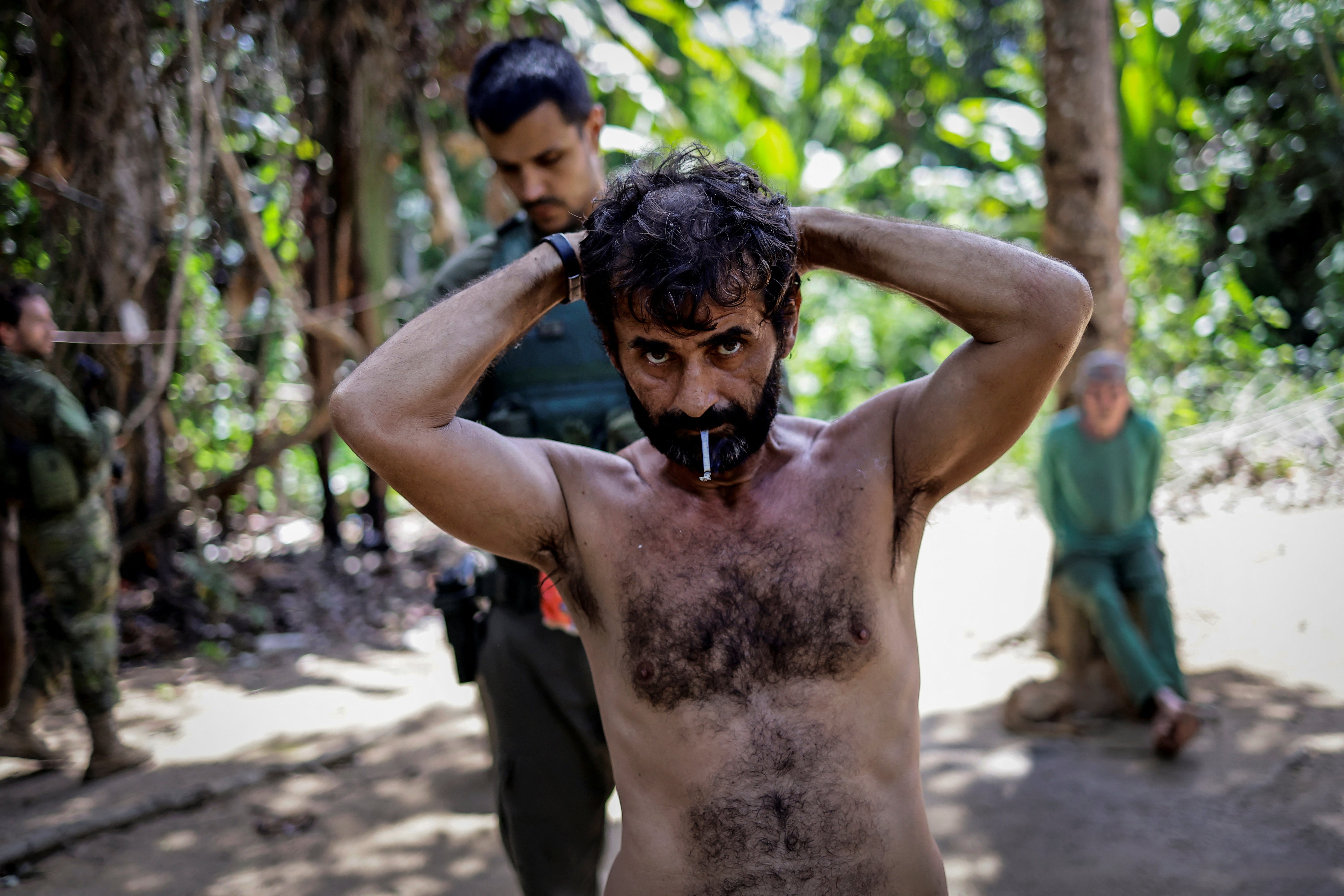 Brazilian government inspectors detain a suspect during an operation against illegal mining in Yanomami Indigenous land