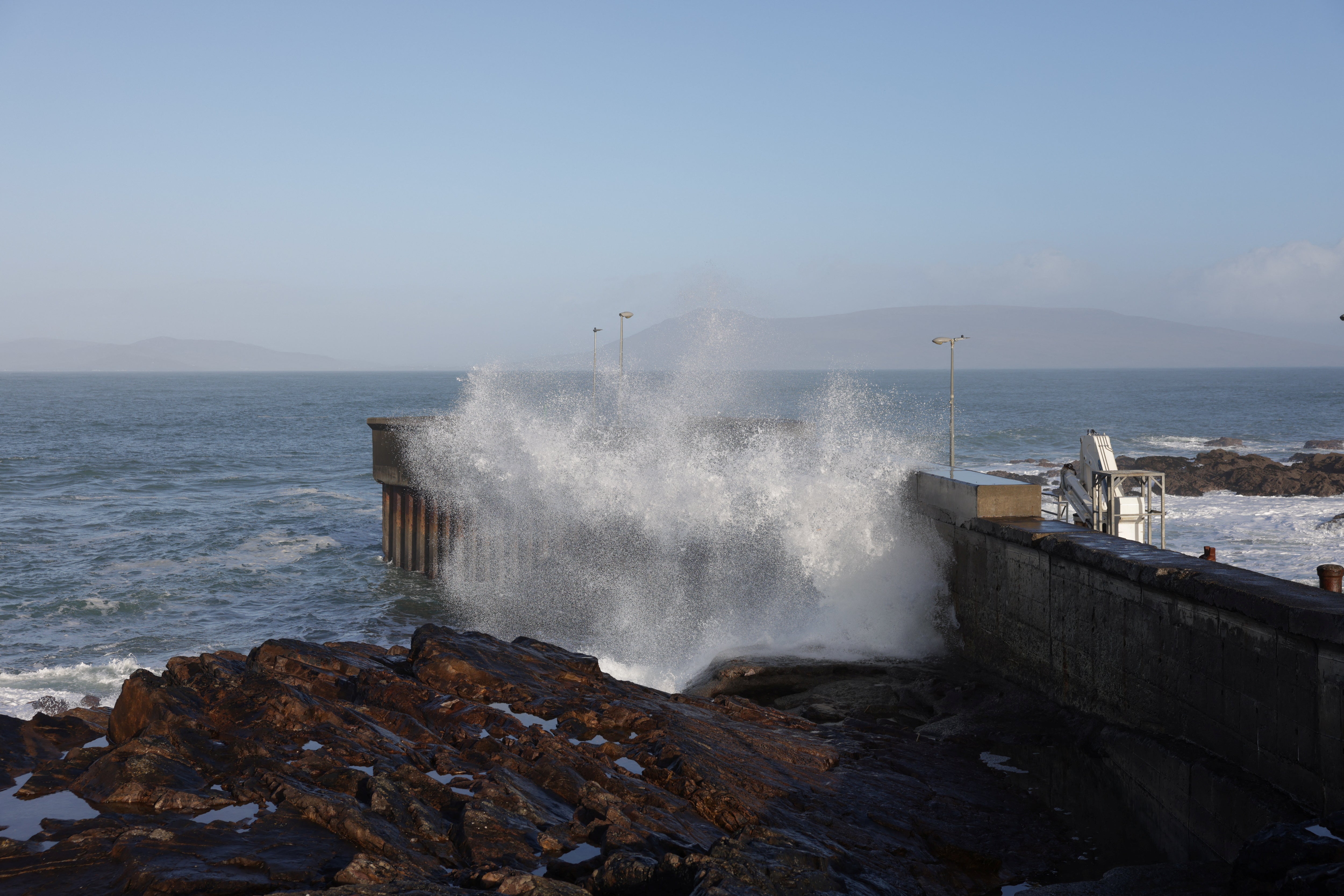 Large waves hit the pier wall, as Storm Jocelyn abates in Roonagh, County Mayo, Ireland