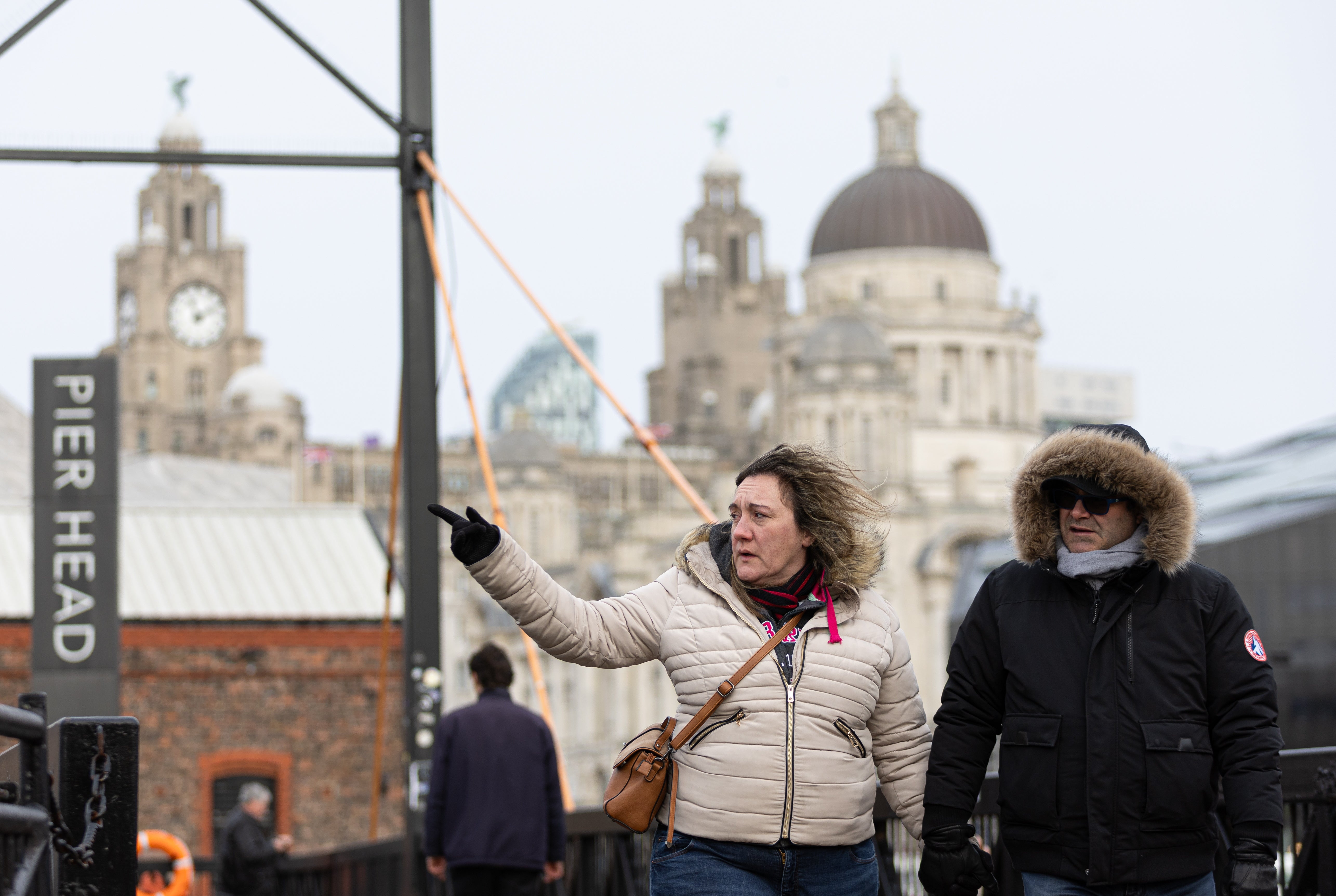 A person's hair is blown in the wind at the Pier Head in Liverpool, Britain, 24 January