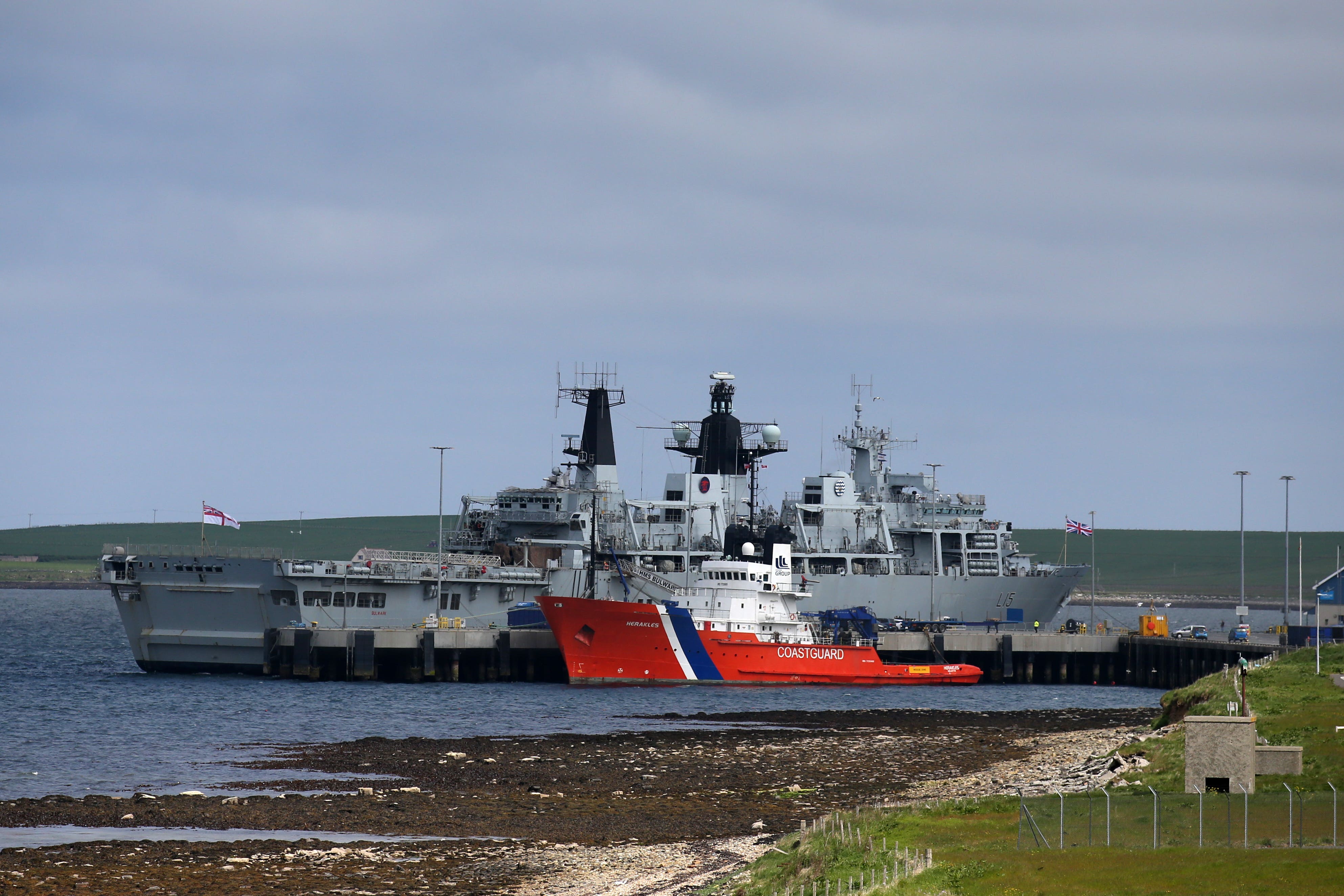 HMS Bulwark in dock alongside coastguard ship Herakles at Kirkwall in Orkney.