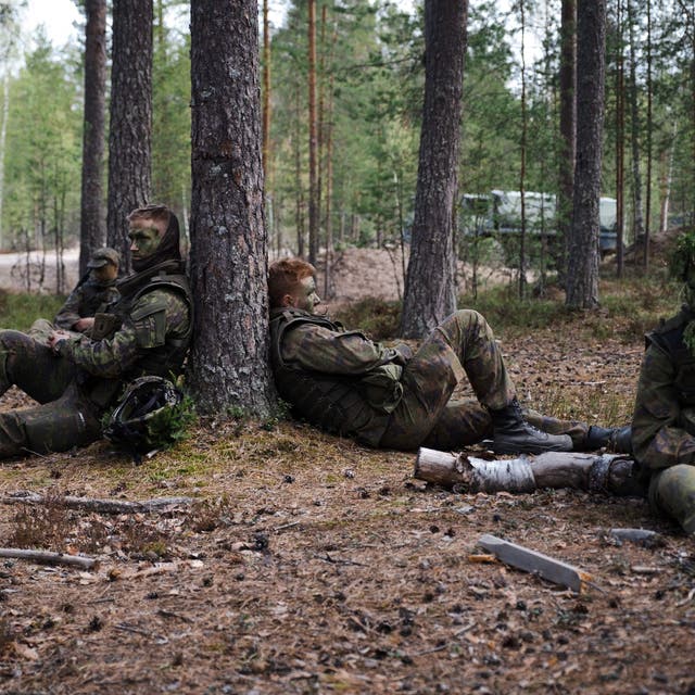 <p>Finnish conscripts are seen resting during a military trainin</p>