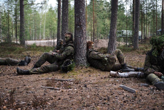 <p>Finnish conscripts are seen resting during a military trainin</p>