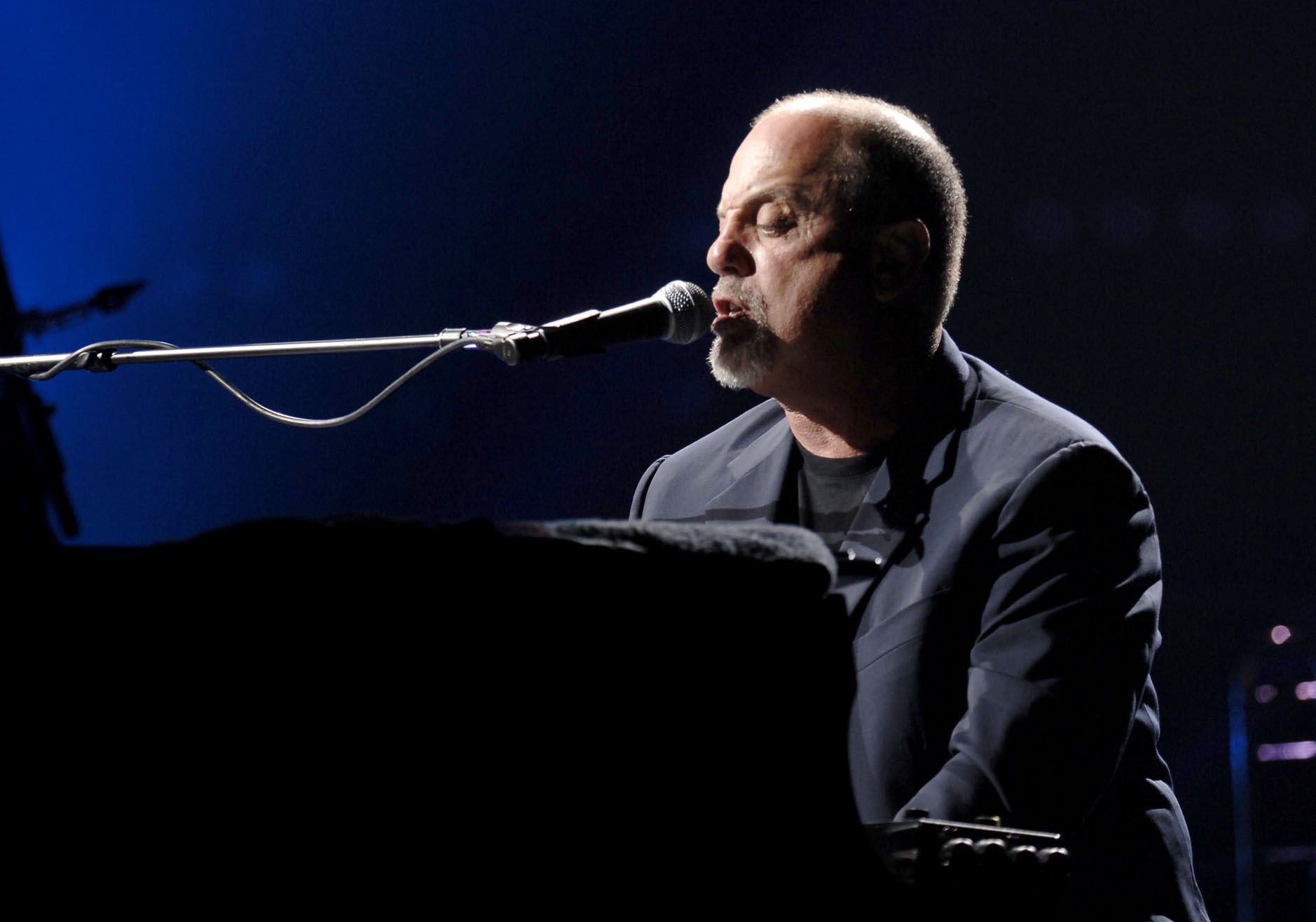 Billy Joel performs on stage at Wembley Arena