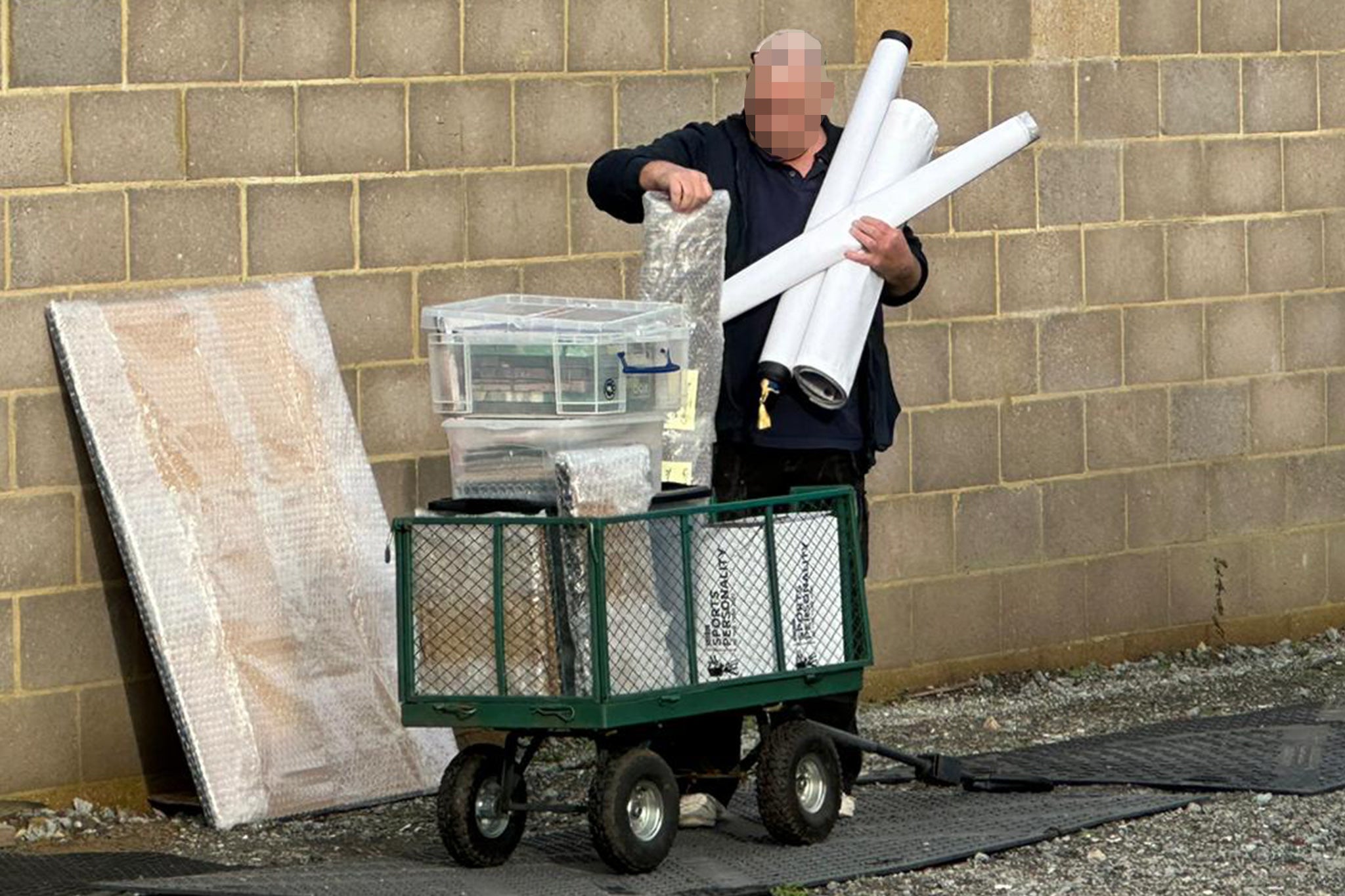 <p>Items including boxes with BBC Sports Personality of the Year logos are removed from the unauthorised building in Sir Captain Tom Moore’s family home</p>