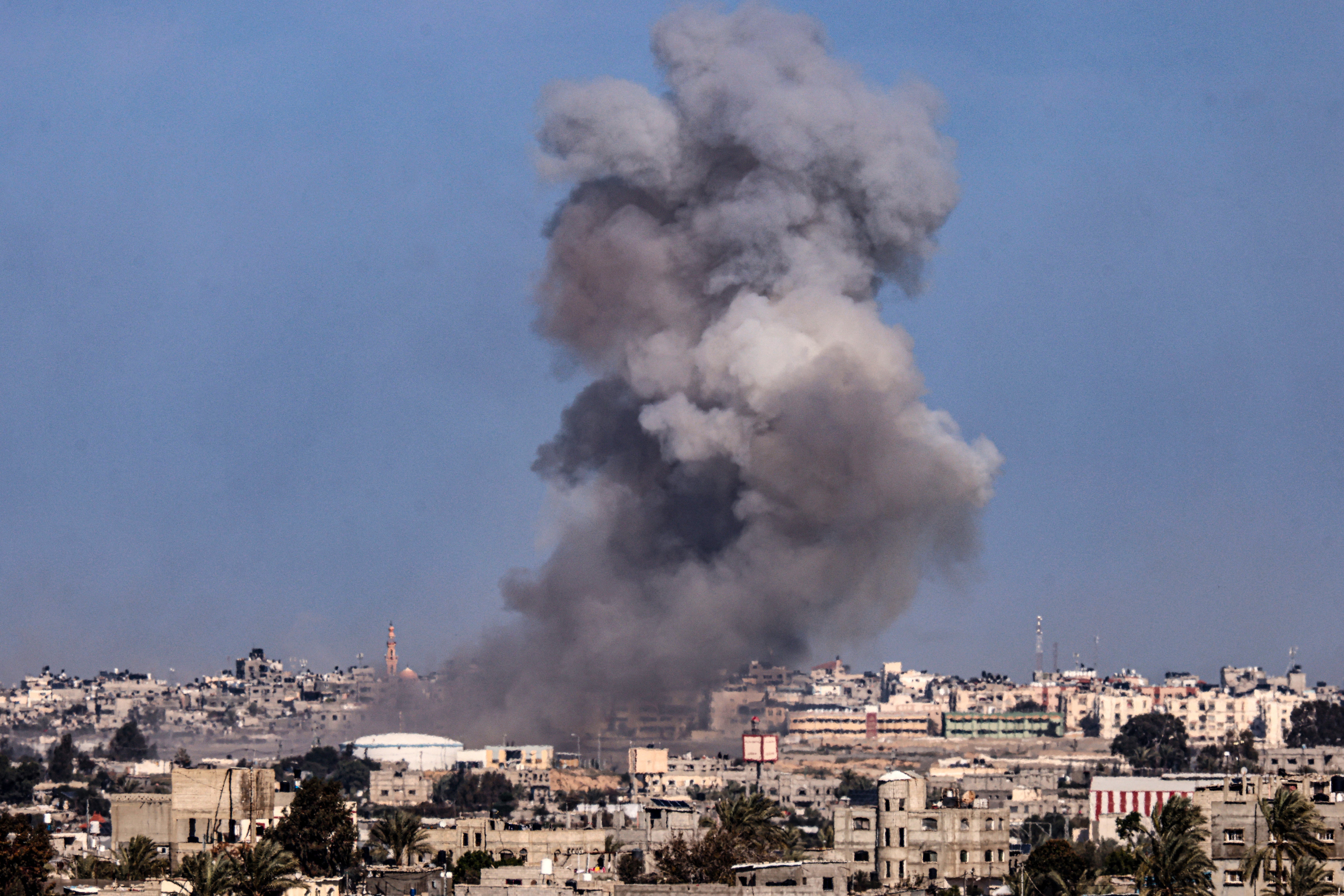 Smoke billows over buildings in southern Gaza following Israeli airstrikes