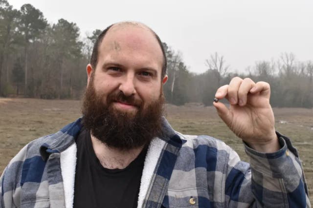 <p>Julien Navas, of Paris, with the 7.46-carat diamond he found at Crater of Diamonds State Park in Arkansas</p>