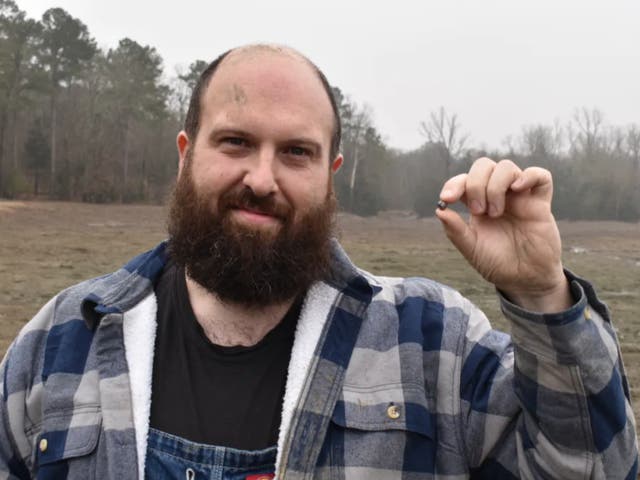 <p>Julien Navas, of Paris, with the 7.46-carat diamond he found at Crater of Diamonds State Park in Arkansas</p>