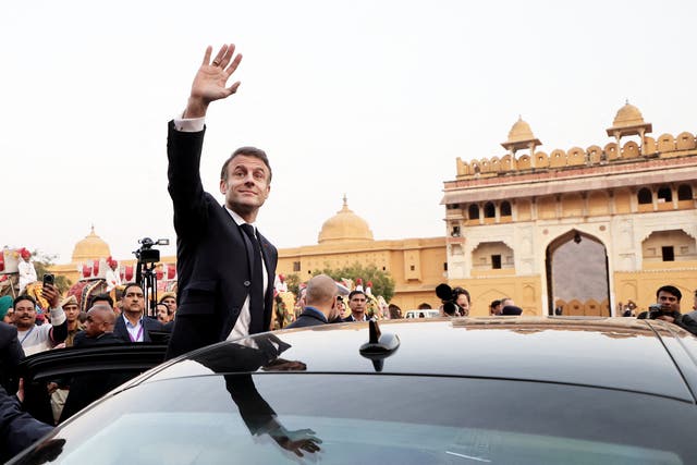 <p>French President Emmanuel Macron waves as he attends a welcoming ceremony at Amber Fort in Jaipur</p>