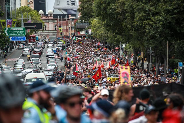 <p> Demonstrators march towards Victoria Park during an Invasion Day protest </p>