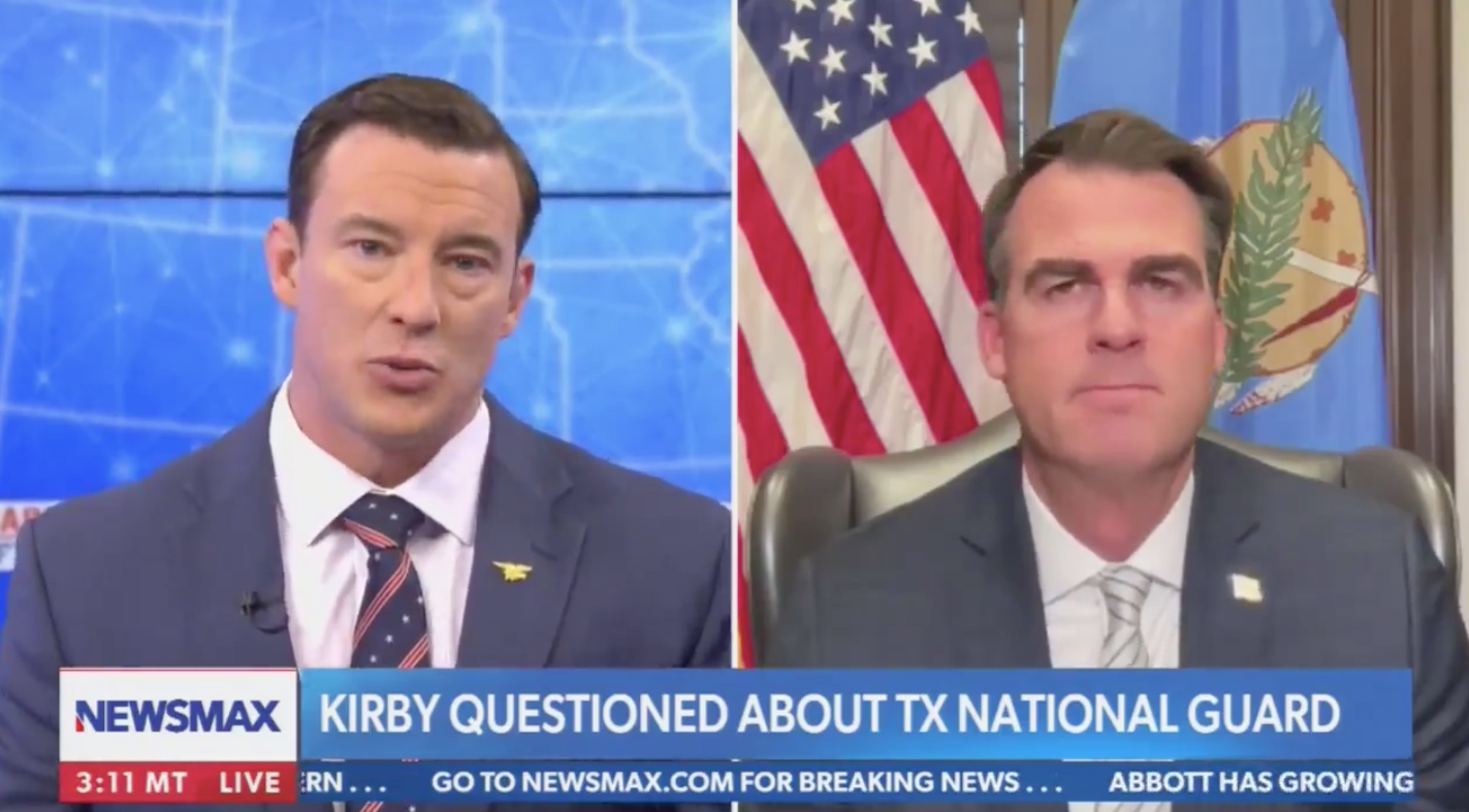 Newsmax has come under fire after airing a segment in which the channel’s host Carl Higbie (left) and Oklahoma Governor Kevin Stitt discussed a potential “force-on-force” conflict between the south and the Biden Administration