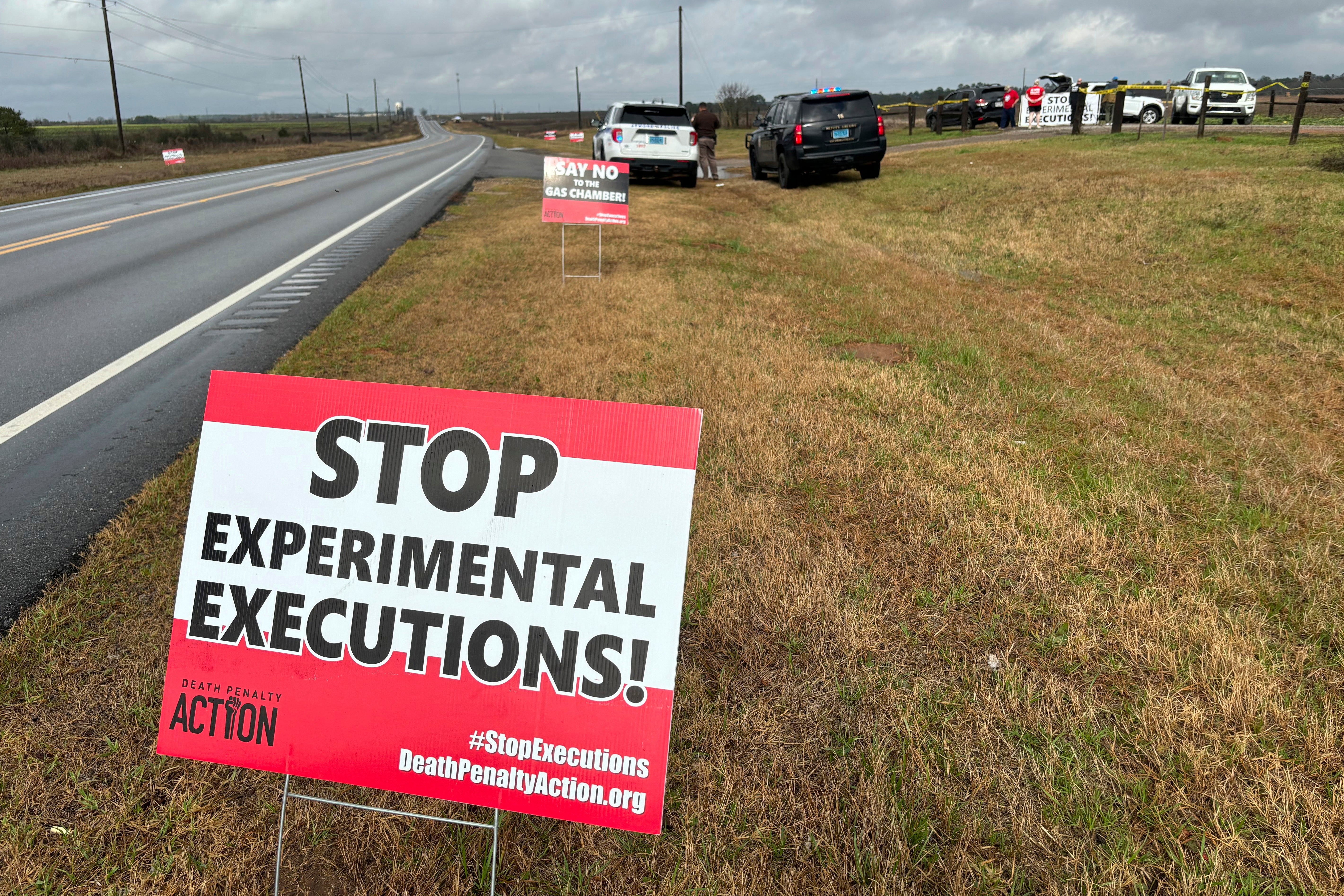 Anti-death penalty signs placed by activists stand along the road heading to Holman Correctional Facility in Atmore as Kenneth Smith was put to death