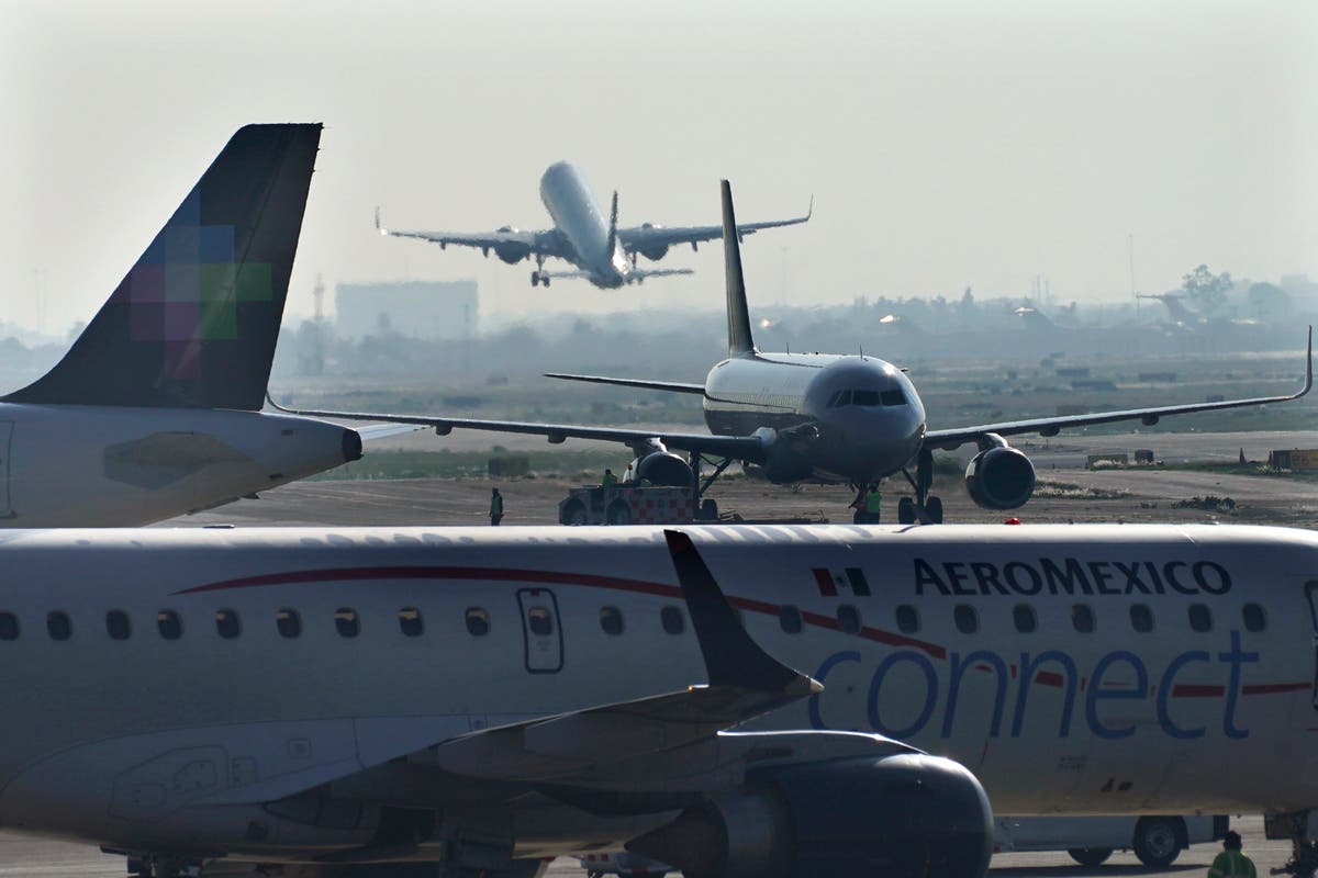 Passengers offer support to man who opened emergency exit and walked onto plane’s wing in Mexico