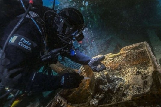 Underwater archaeologist Marc-André Bernier inspects a seamen’s chest on Erebus