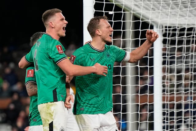 <p>Dan Burn, right, celebrates after scoring for the Magpies </p>