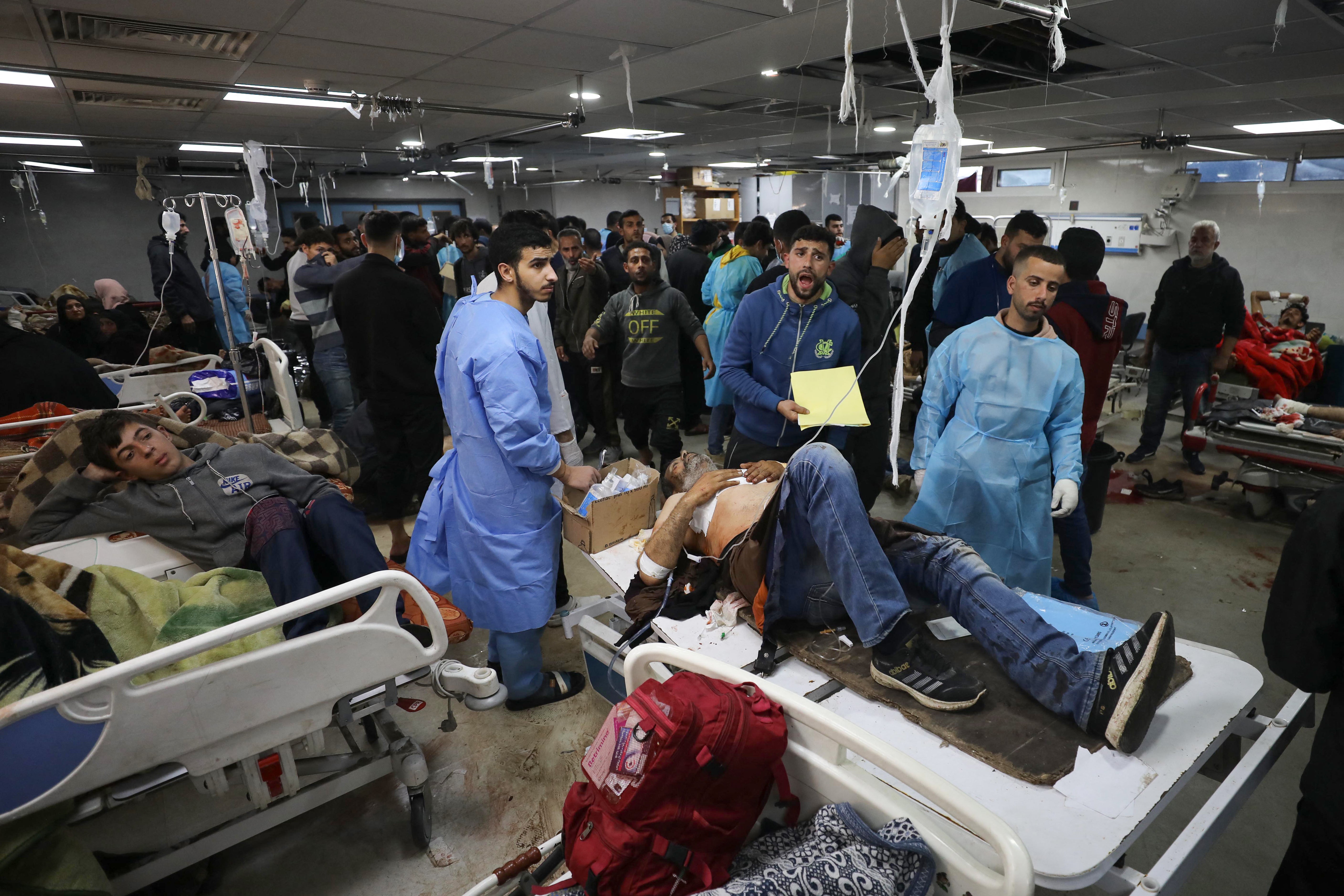 Injured Palestinians are brought to al-Shifa hospital in Gaza City following an Israeli airstrike on Sunday