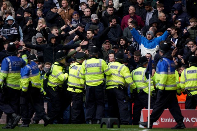 <p>Police officers attempt to contain trouble between rival fans during West Brom’s FA Cup fourth-round tie against Wolves (Bradley Collyer/PA)</p>
