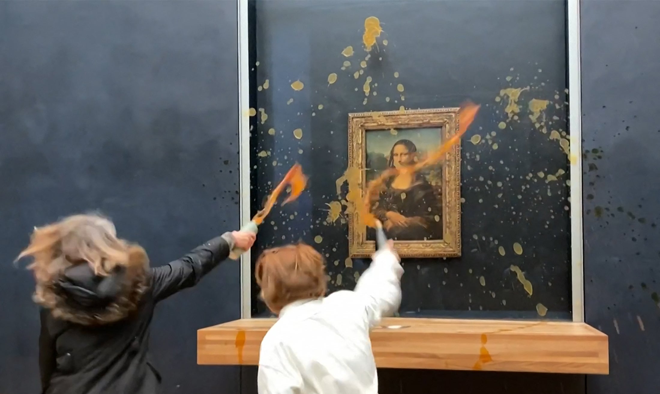 A tin of pumpkin soup was hurled over the painting which is encased in bulletproof glass