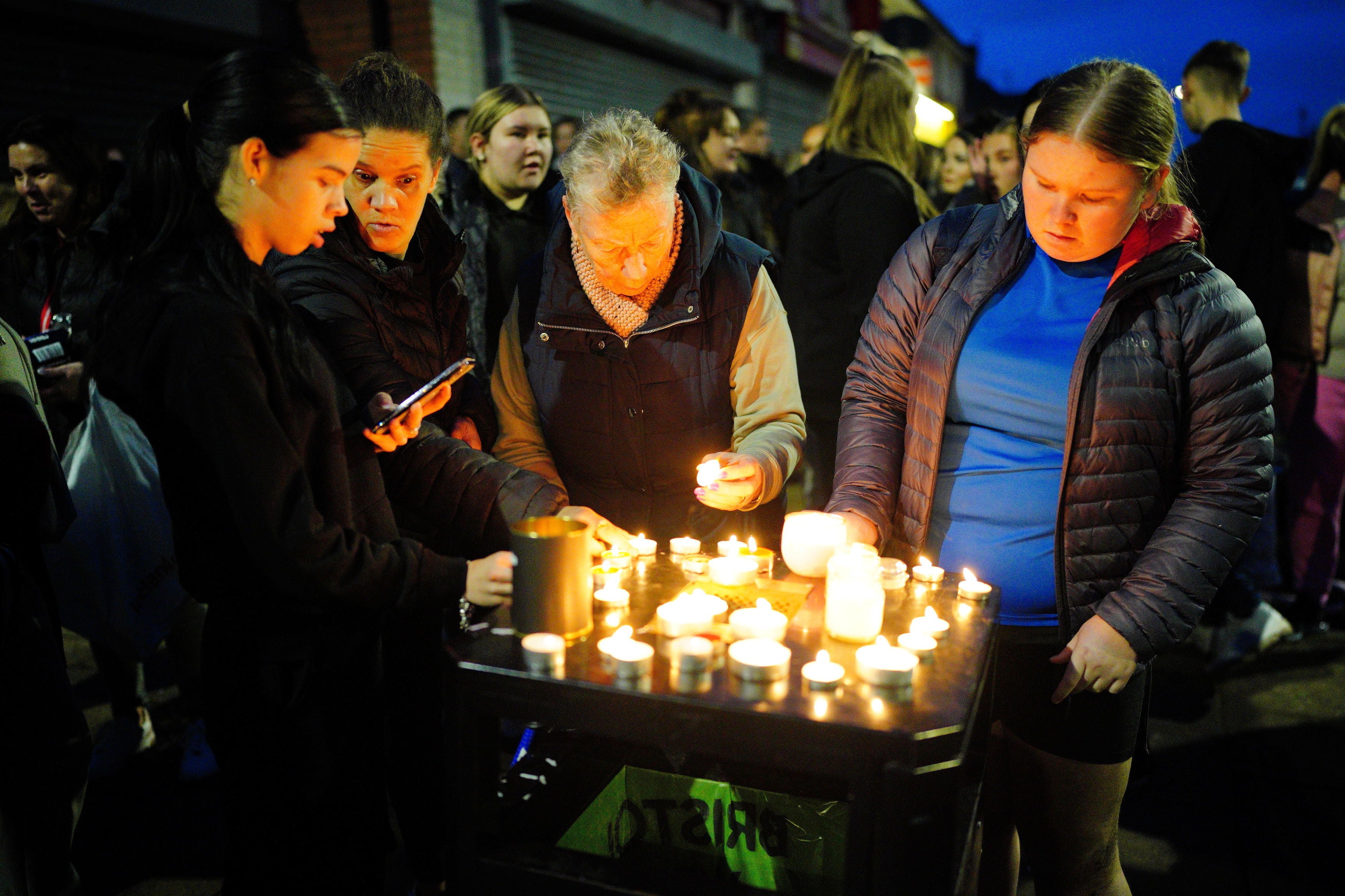 People take part in a vigil near to the scene in south Bristol