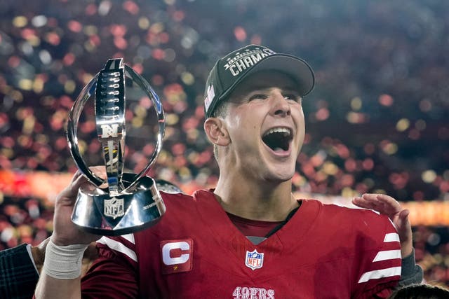 San Francisco 49ers quarterback Brock Purdy celebrates with the trophy after their win against the Detroit Lions in the NFC Championship (Godofredo A Vasquez/AP)