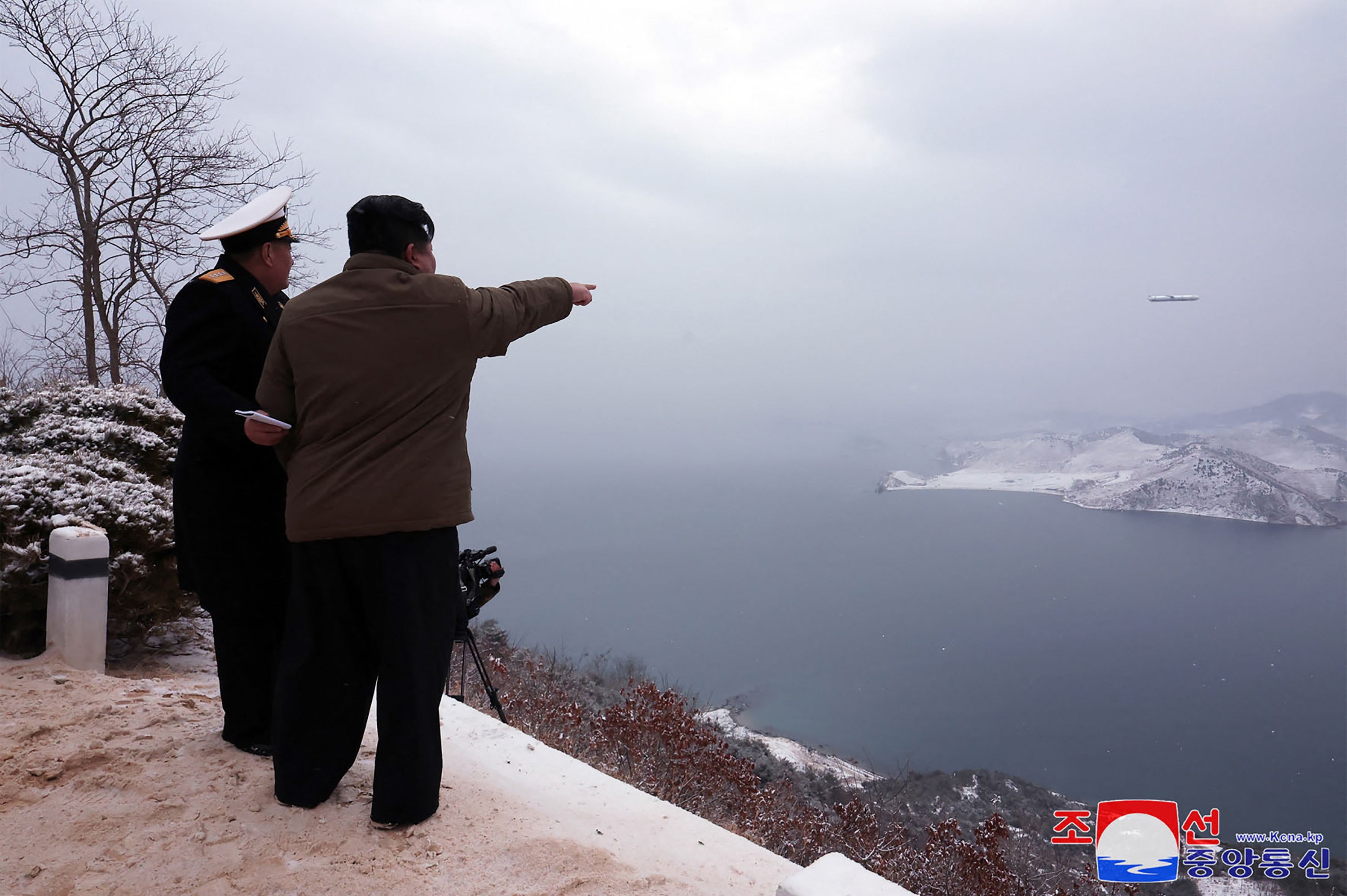 The North Korean leader Kim Jong-un (right) inspects a test-fire of the submarine-launched strategic cruise missile ‘Pulhwasal-3-31’