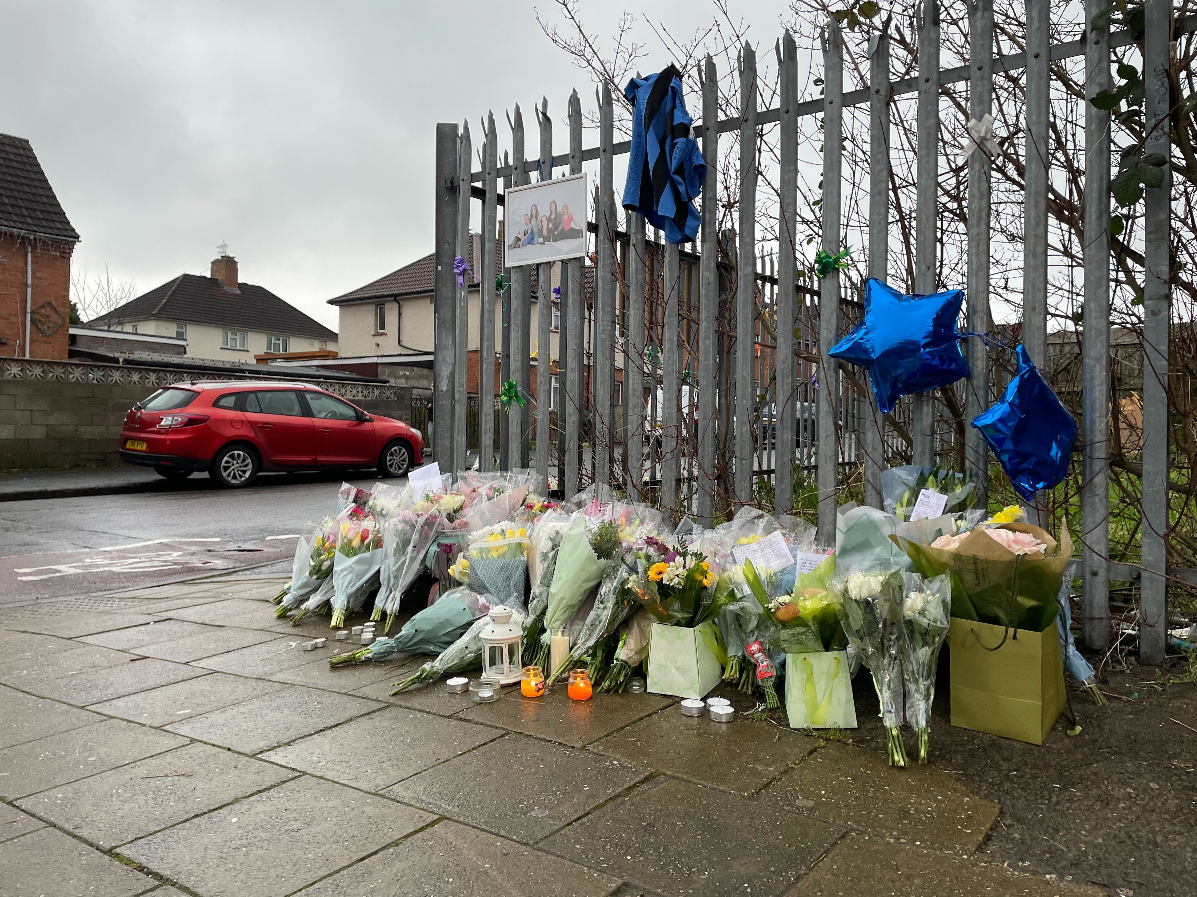 Tributes, candles and a family picture were left at the scene